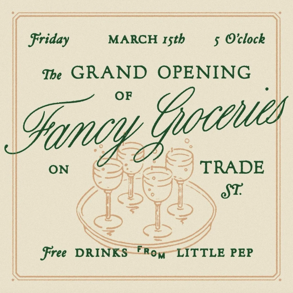 Cream invitation card for the grand opening of Fancy Groceries, with green engraved-style serif capitals, a flowing script store name and a line drawing of four glasses on a tray.