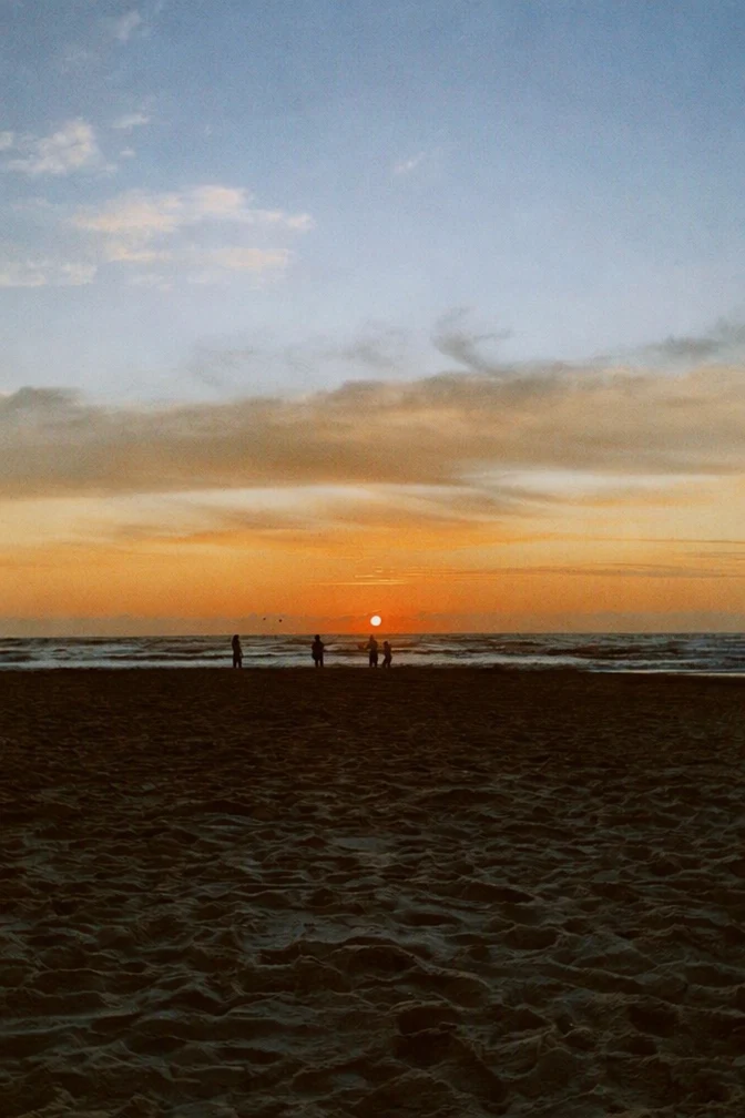 The same beach sunset with the date stamp removed and the sand filled in where the digits were.